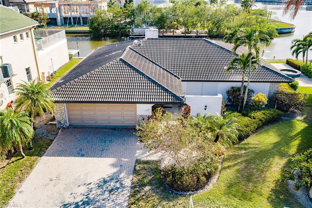 128 Heron Avenue Naples, FL 34108 - Photo 6 of 12 a backyard of a house with lots of green space
