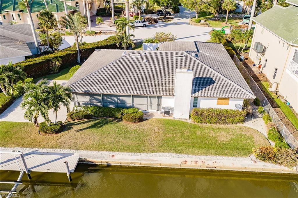 128 Heron Avenue Naples, FL 34108 - Photo 8 of 12 a view of swimming pool with outdoor seating and plants