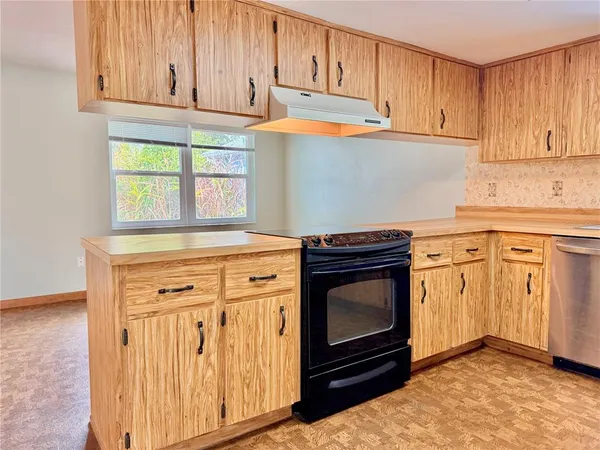 a kitchen with granite countertop white cabinets stainless steel appliances and sink
