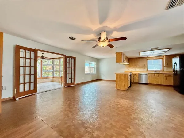 a view of an empty room with window and cabinet