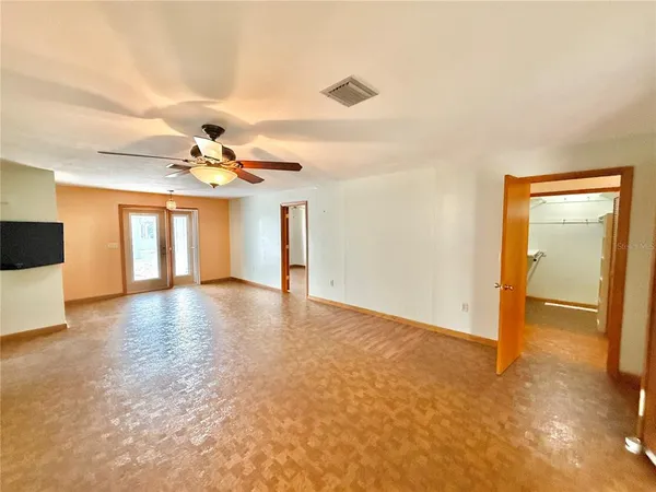 a view of an empty room with a chandelier