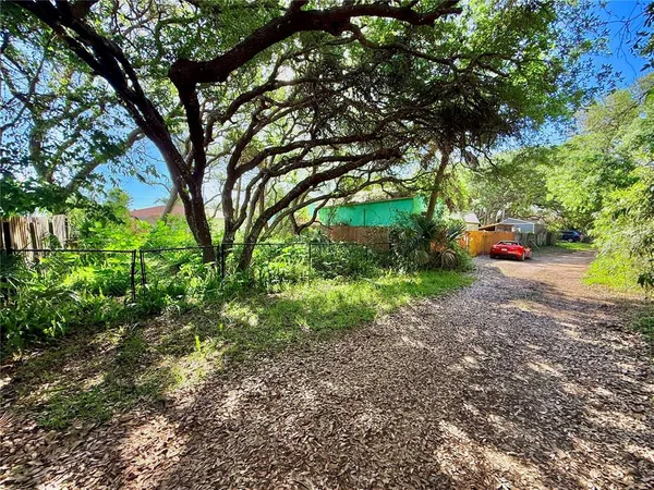 an aerial view of a house with a yard and lake view