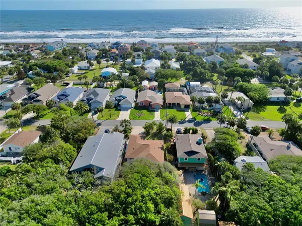 an aerial view of a house with a yard and garden