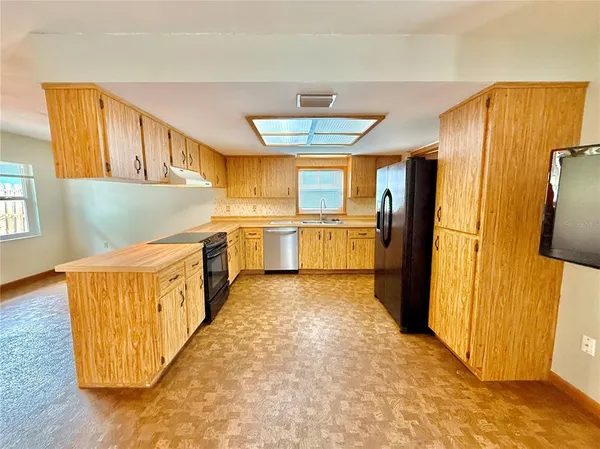 a kitchen with stainless steel appliances a refrigerator and a stove