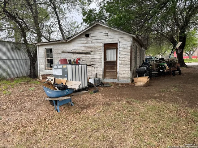 a view of a house with backyard and chairs