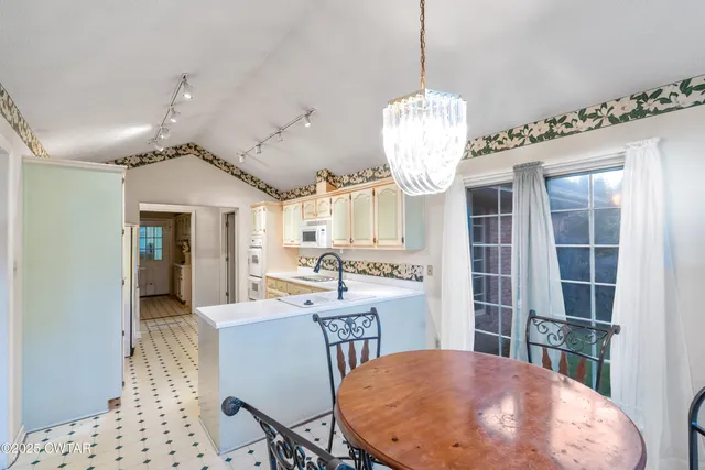a view of a room with furniture and a chandelier