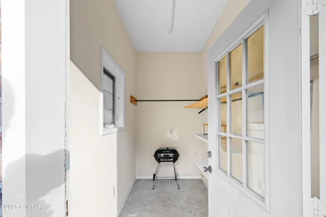 an aerial view of residential house with outdoor space and trees all around
