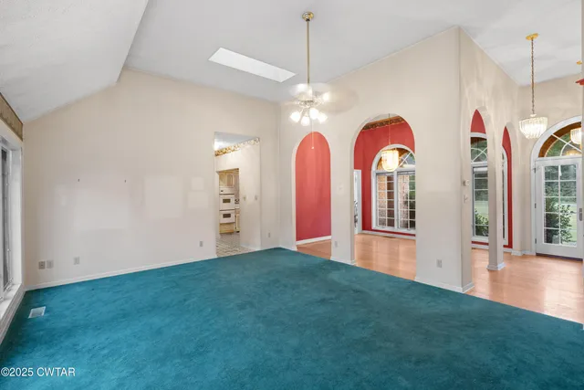 a view of a room with windows and chandelier