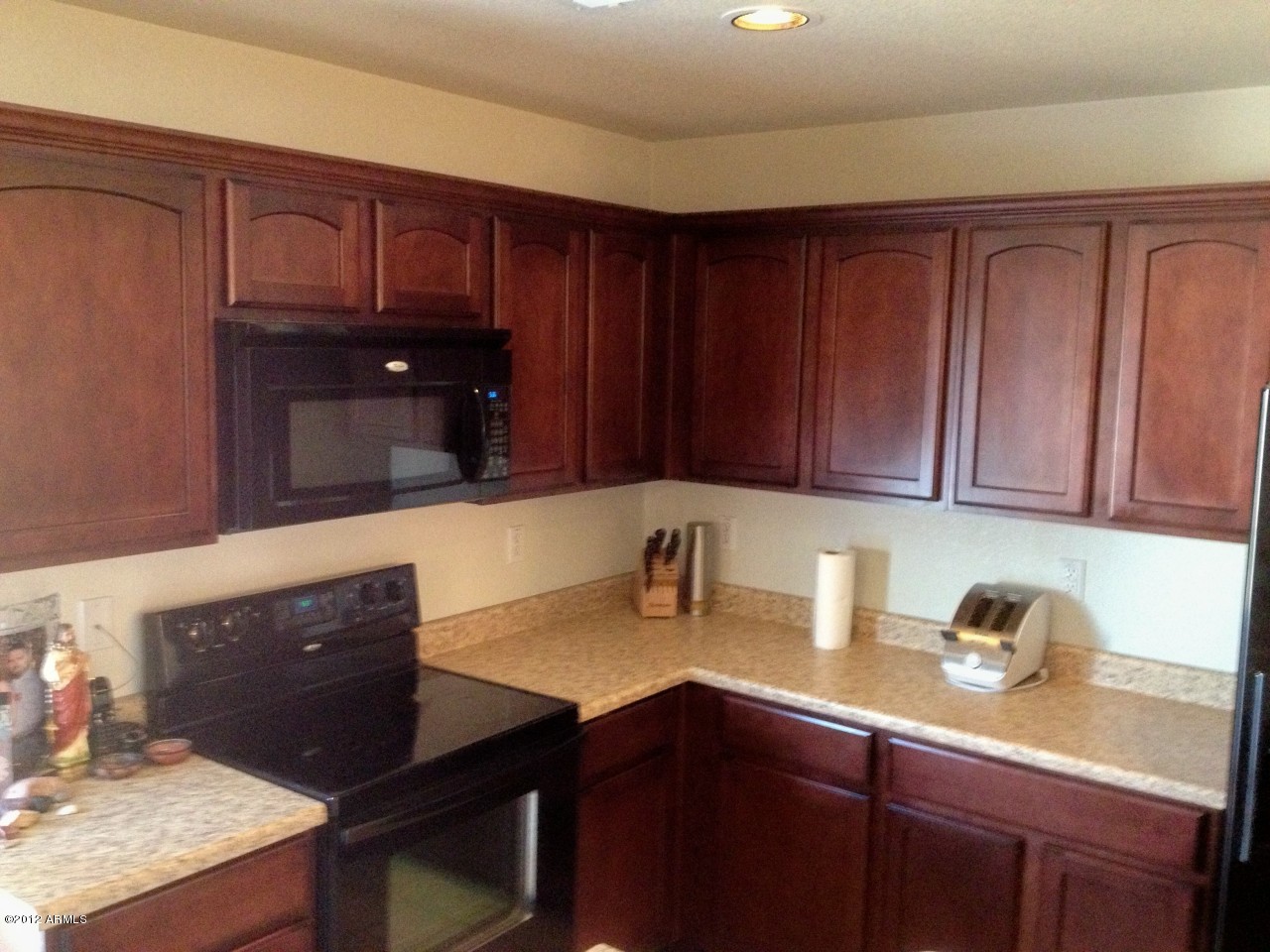 6351 West Beverly Road Laveen, AZ 85339 - Photo 4 of 12 a kitchen with granite countertop wooden cabinets and a sink