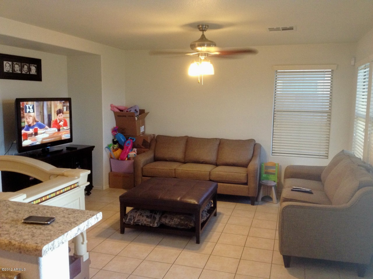 6351 West Beverly Road Laveen, AZ 85339 - Photo 5 of 12 a living room with furniture and a flat screen tv