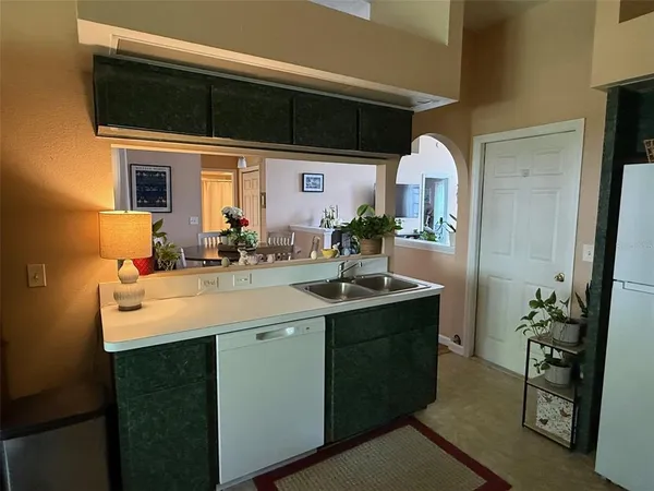 a kitchen with stainless steel appliances a refrigerator and a stove