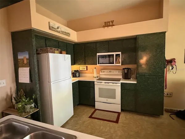 a kitchen with a refrigerator sink and stove