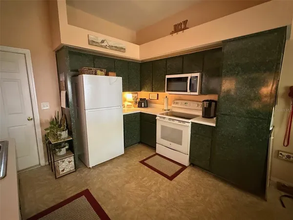 a kitchen with stainless steel appliances a refrigerator stove and microwave