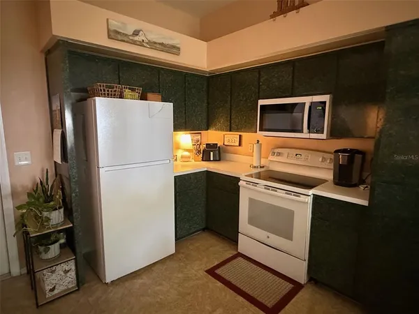 a kitchen that has a sink a table and chairs in it