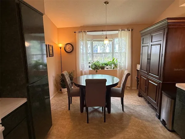 a view of a dining room with furniture and window