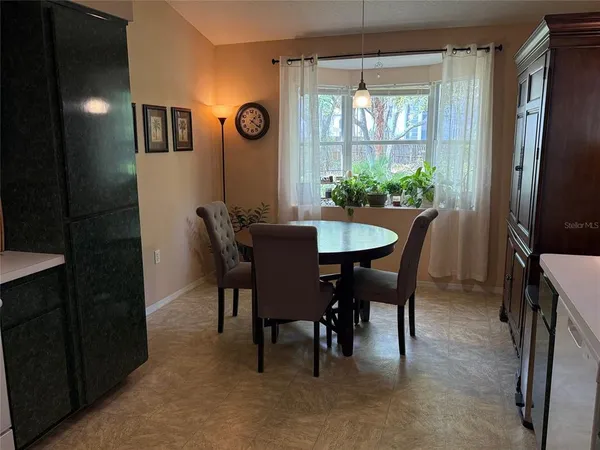 a dining room with furniture and window