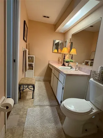a bathroom with a toilet sink and mirror