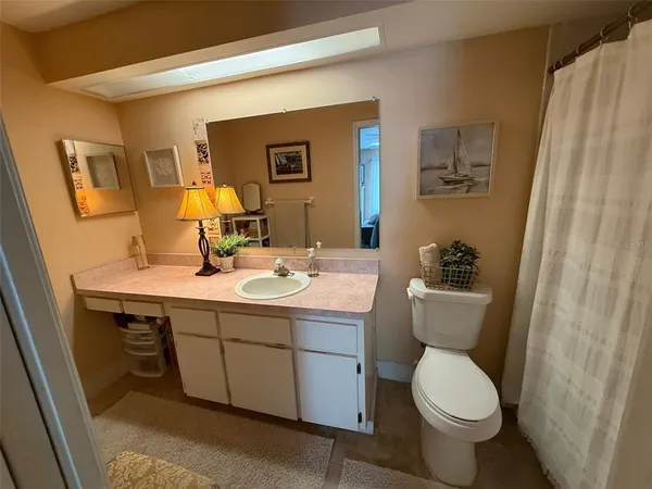 a bathroom with a sink a toilet and mirror