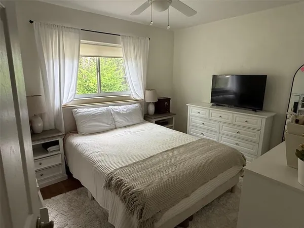 a bathroom with a sink a toilet a mirror and shower curtain