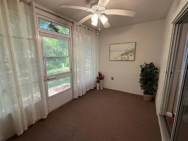 a view of a livingroom with furniture and a hallway