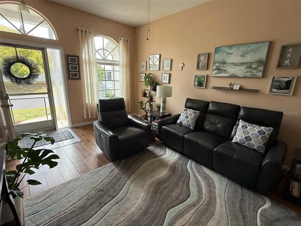 a living room with furniture window and wooden floor
