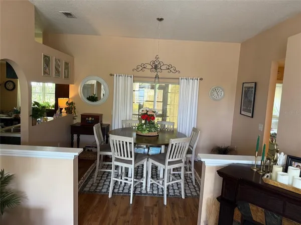 a view of a dining room with furniture and a large window