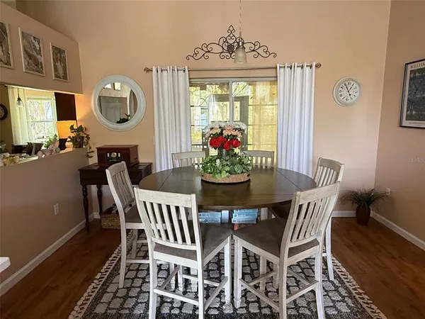 a view of a dining room with furniture and a chandelier