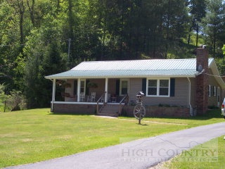 603 Charlie King Road Lansing, NC 28643 - Photo 1 of 1 a front view of house with yard outdoor seating and green space