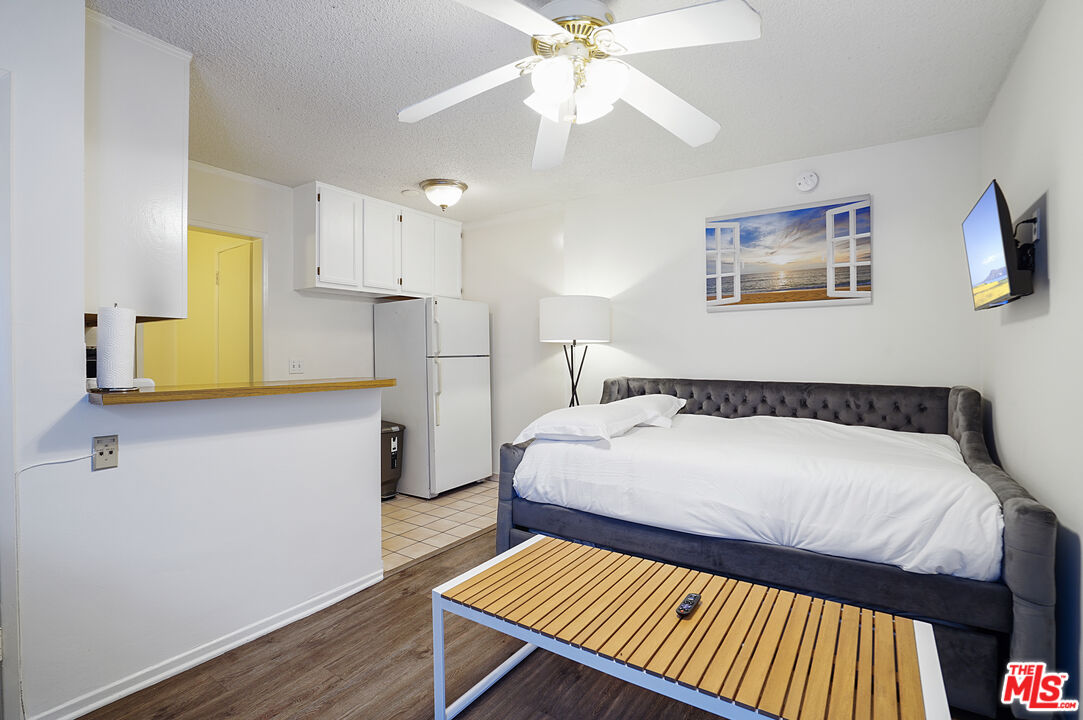 a bedroom with a bed and wooden floor