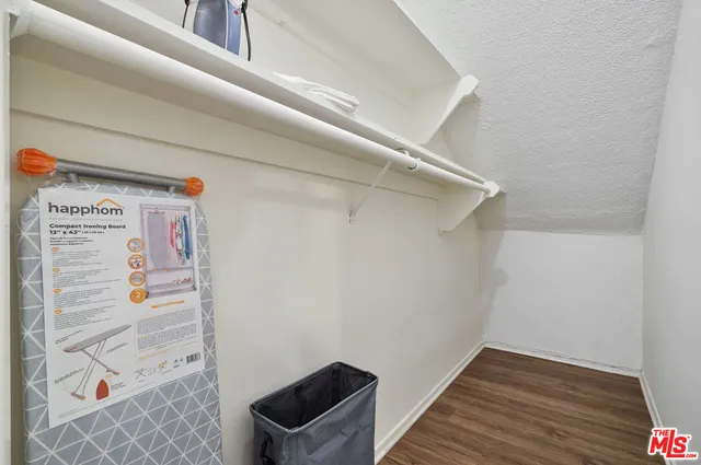 a bed sitting in a bedroom and a lamp