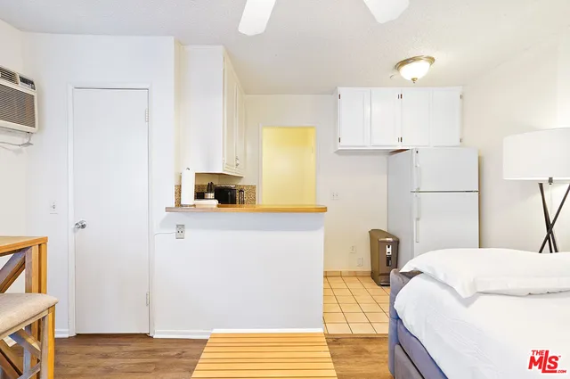 a view of cabinets with wooden floor and chair