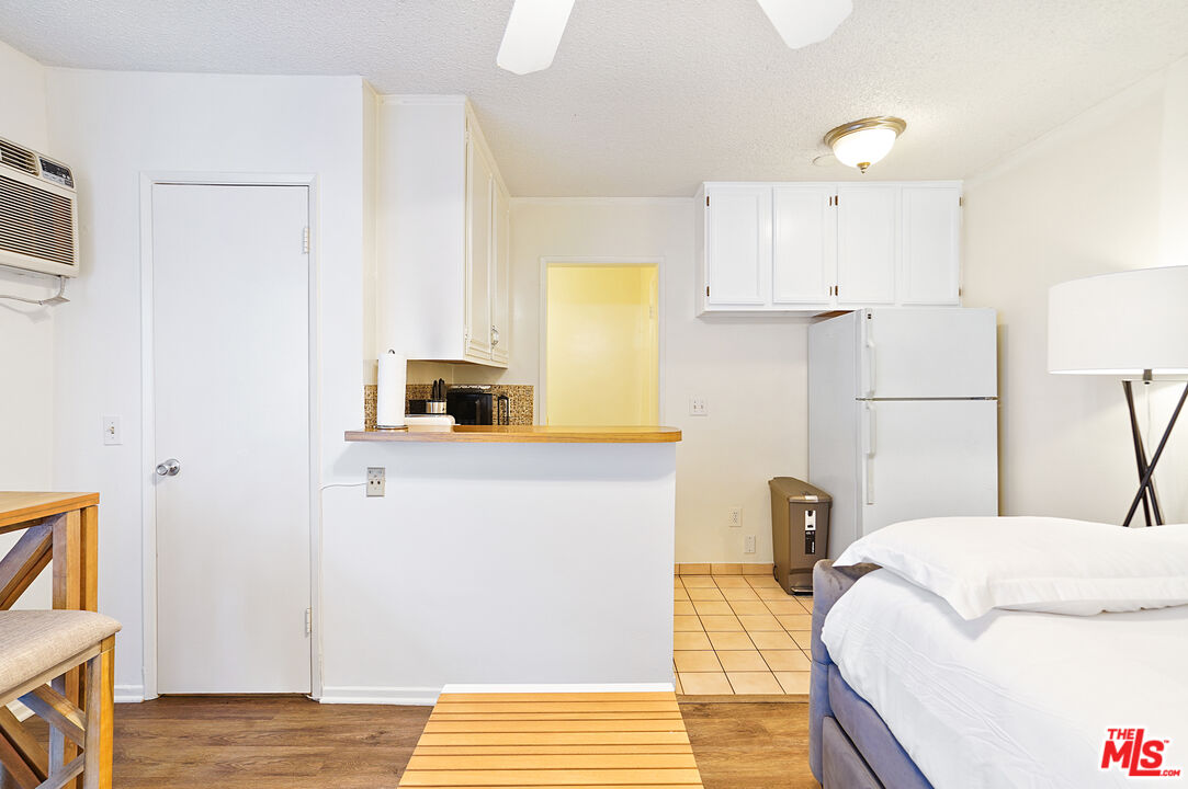 3720 Vinton Avenue, Unit 1A Los Angeles, CA 90034 - Photo 14 of 15 a bedroom with a bed and a view of kitchen