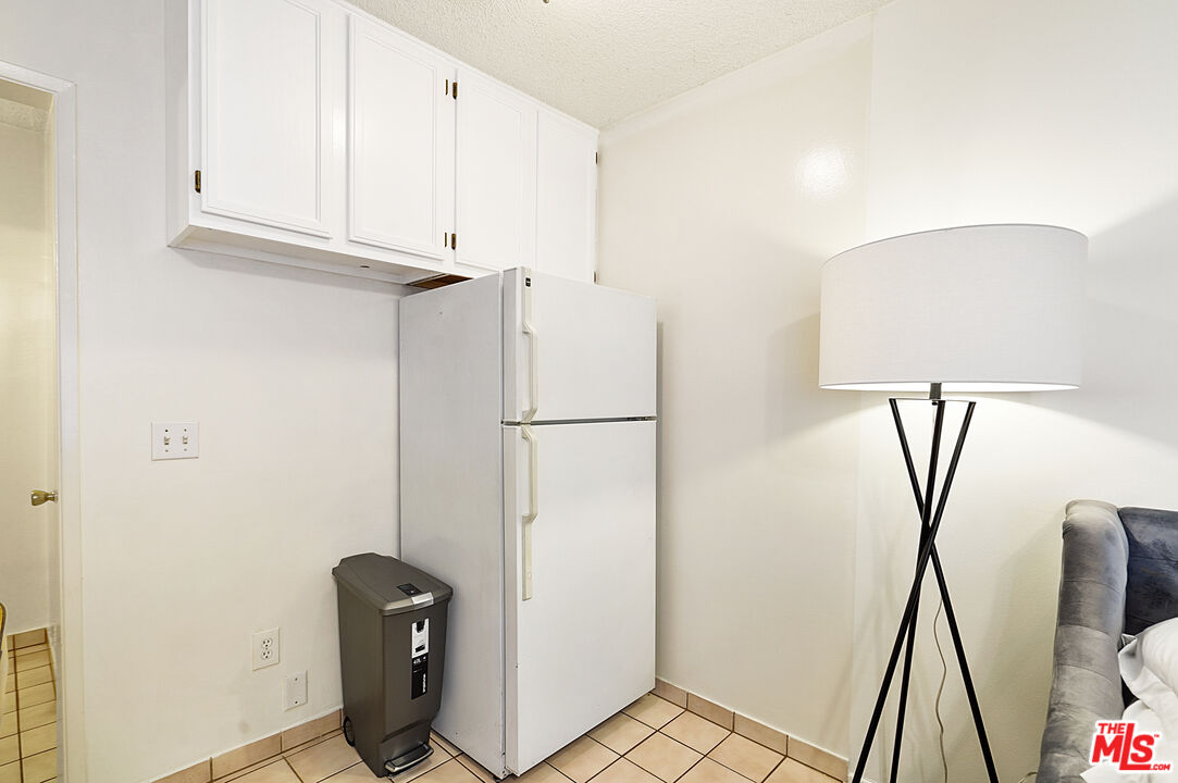 3720 Vinton Avenue, Unit 1A Los Angeles, CA 90034 - Photo 15 of 15 a view of cabinets with wooden floor and chair