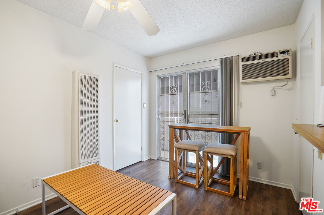 3720 Vinton Avenue, Unit 1A Los Angeles, CA 90034 - Photo 5 of 15 a bedroom with a bed a table and wooden floor