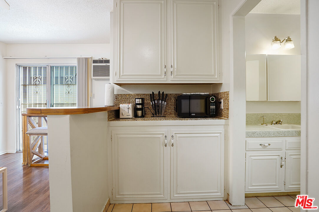 3720 Vinton Avenue, Unit 1A Los Angeles, CA 90034 - Photo 7 of 15 a kitchen with white cabinets and sink