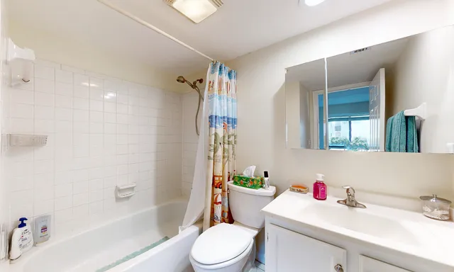 a bathroom with a sink mirror vanity and bathtub