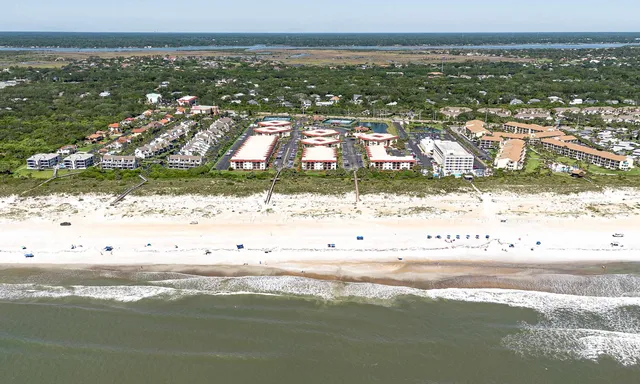 a view of a house with wooden fence