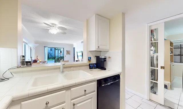 a kitchen with stainless steel appliances a sink a stove and cabinets