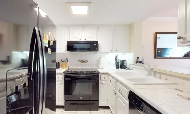 a kitchen with a sink stove and refrigerator