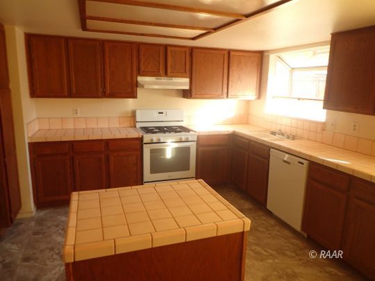 505 East Wilson Avenue Ridgecrest, CA 93555 - Photo 3 of 14 a kitchen with a sink cabinets and window