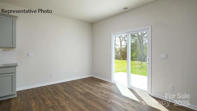 a view of an empty room and wooden floor