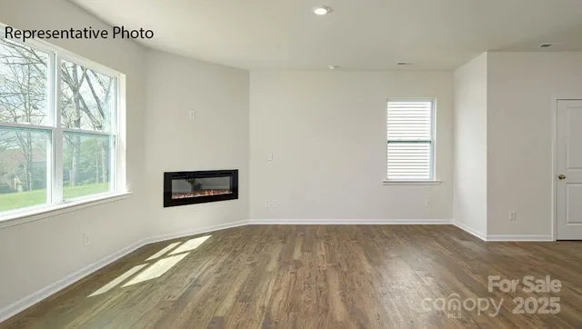 a view of a room with wooden floor and windows