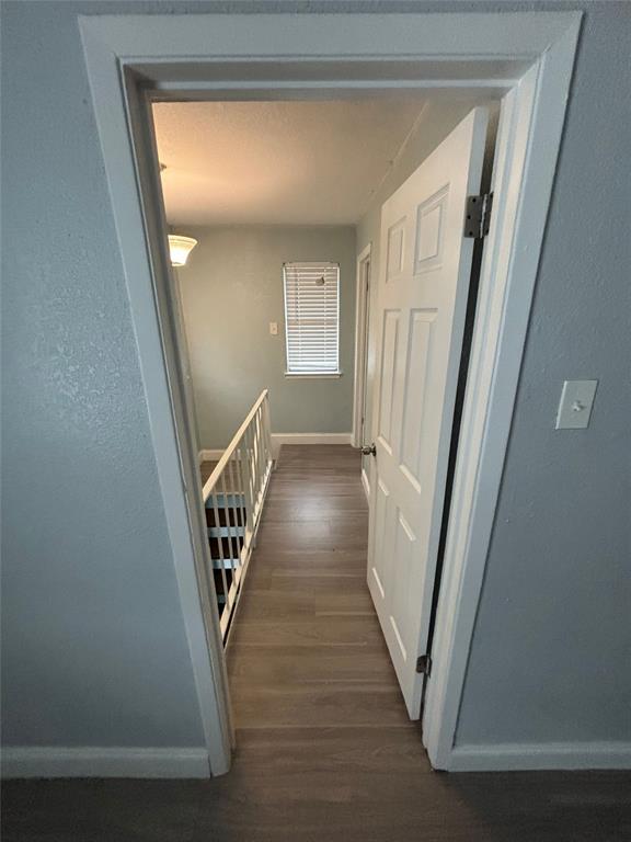 301 Rolston Road, Unit 315101 Irving, TX 75060 - Photo 2 of 12 Hallway featuring wood-finish flooring and a white paneled door