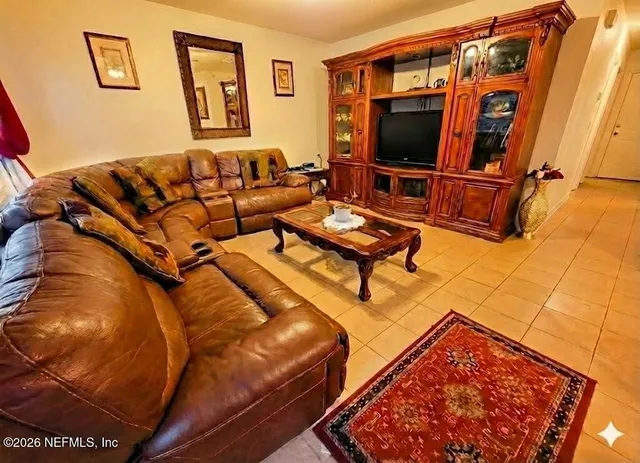 a living room with furniture and a flat screen tv