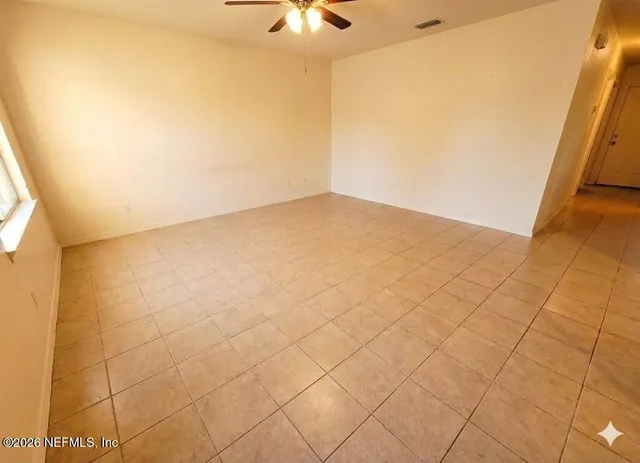 a view of a dining room with furniture and window