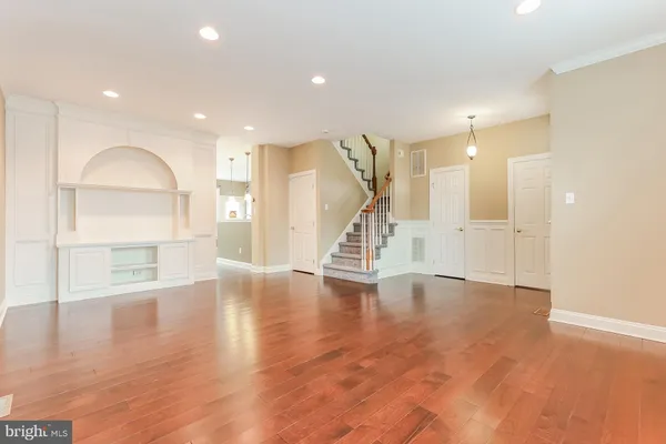 a view of an empty room with wooden floor