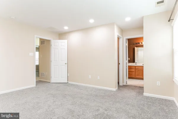 an empty room with a bathroom and a sink