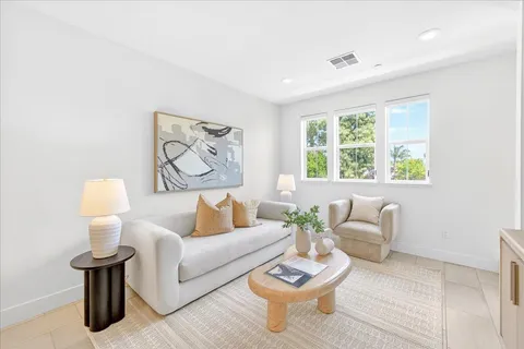 a living room with furniture cabinets and window