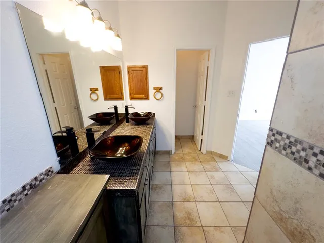 a bathroom with a sink a toilet and a mirror