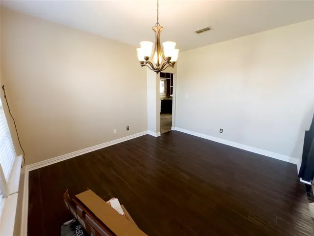 a view of a room with wooden floor and windows